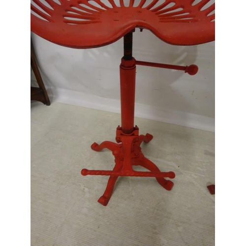 202 - A pair of metal tractor seat stools. (adjustable)