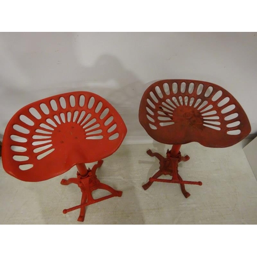 202 - A pair of metal tractor seat stools. (adjustable)