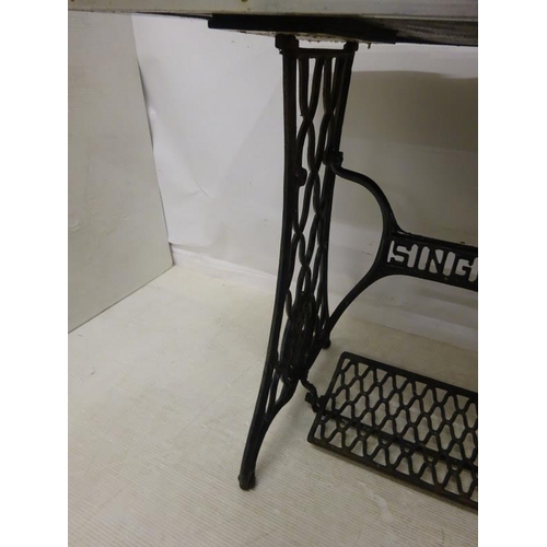 205 - Garden table with tiled top on singer base. 90cm x 60cm approx.