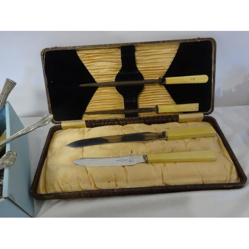 21 - Box of assorted cutlery and a carving set.