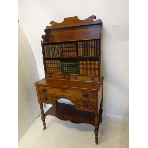 222 - A good antique mahogany desk top bookshelves fitted with five drawers and raised on ring turned legs... 