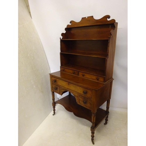 222 - A good antique mahogany desk top bookshelves fitted with five drawers and raised on ring turned legs... 