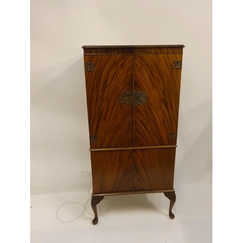 308 - Walnut four door drinks cabinet raised on Queen Anne style legs. H. 148cm, W. 72cm, D. 40cm approx.