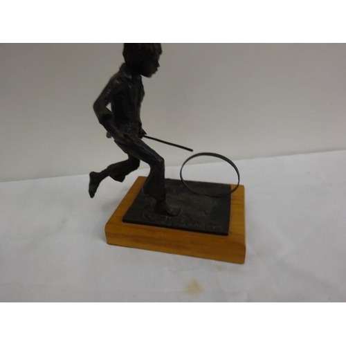 314 - Bronze figure, boy pushing hoop. Signed Sanders.