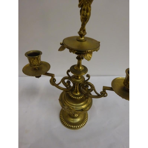 329 - A pair of decorative brass two branch candleabra.