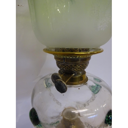 62 - Antique brass and copper column oil lamp having clear glass bowl with green teardrops and old green ... 