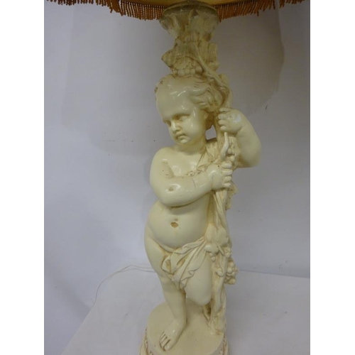 86 - A pair of large cherub figure side lamps with attractive shades.