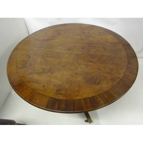 103 - A good Irish antique circular table on turned column and reeded tripod base with brass toe castors, ... 