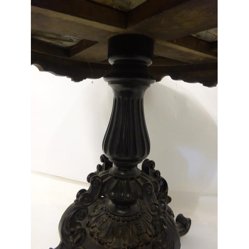 107 - A 19th century table having a circular marble top on an ebonized frame with centre column and carved... 