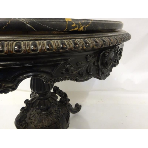 107 - A 19th century table having a circular marble top on an ebonized frame with centre column and carved... 