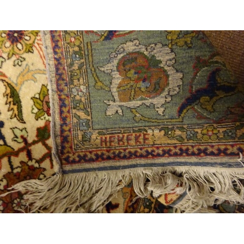 119 - A good Hereke Turkish rug having ivory field and all over design with Hereke inscription to one end.... 