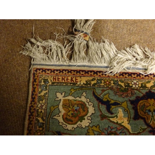 119 - A good Hereke Turkish rug having ivory field and all over design with Hereke inscription to one end.... 