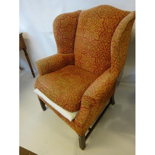 121 - Antique wing back drawing room chair raised on square legs with cross stretcher.