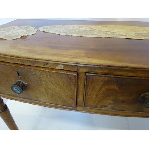 129 - A Cork Regency mahogany bow shaped side table fitted with 3 drawers and raised on turned legs. W. 12... 