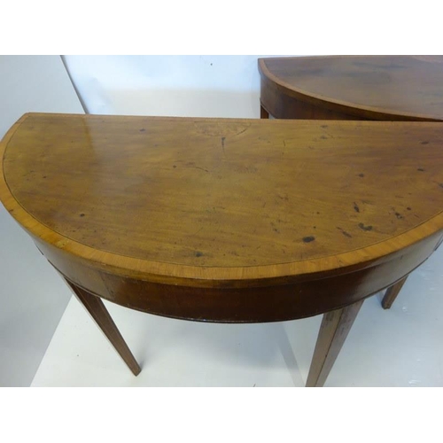 130 - Pair of Georgian Irish mahogany and satinwood banded demi lune side table raised on tapered legs. W.... 