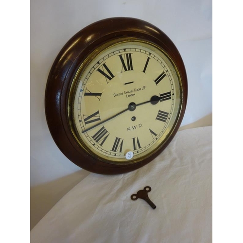 133 - Old Smiths railway clock with key. Diameter 34cm.