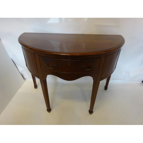 134 - Antique mahogany bow shaped sideboard fitted with a drawer and cupboards and raised on tapered legs.... 