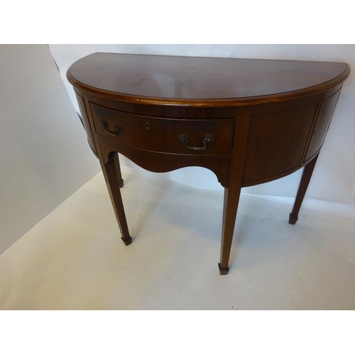 134 - Antique mahogany bow shaped sideboard fitted with a drawer and cupboards and raised on tapered legs.... 