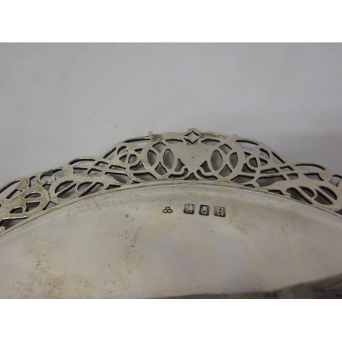 162 - An Irish circular silver salver having pierced decorative border and raised on button type feet. Dub... 