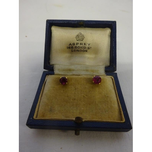 176 - A pair of gold and ruby earrings, Asprey, London.