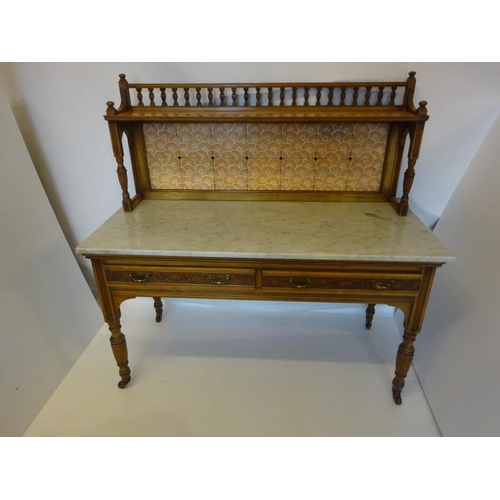 241 - A Victorian walnut washstand, the upper section having spindle gallery and tiled paneled back, the b... 