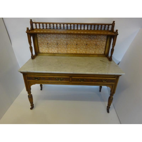 241 - A Victorian walnut washstand, the upper section having spindle gallery and tiled paneled back, the b... 