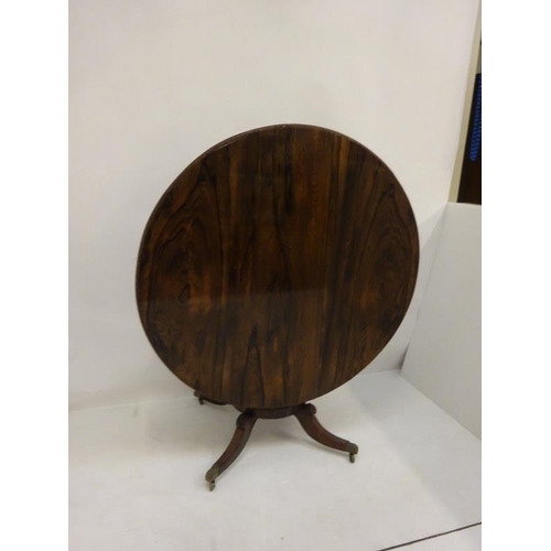 242 - A Regency rosewood circular dining table raised on turned column platform base and 4 splay legs with... 