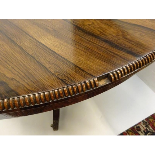 242 - A Regency rosewood circular dining table raised on turned column platform base and 4 splay legs with... 