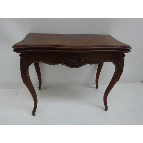 243 - Victorian mahogany card table, the shaped top over carved freize and raised on cabriole legs. W. 85c... 