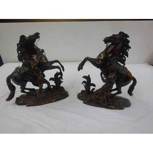 330 - A good pair of antique bronze marley horses with horsemen.