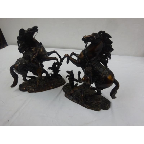 330 - A good pair of antique bronze marley horses with horsemen.