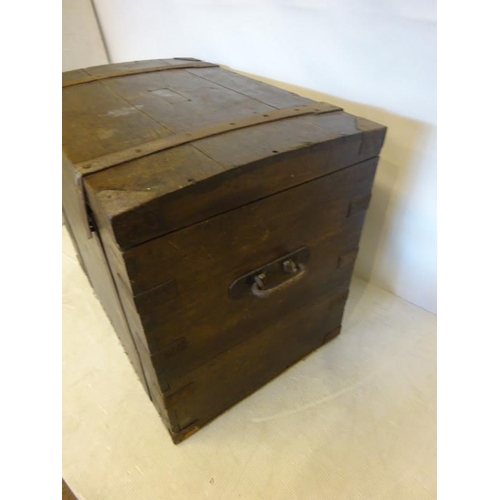 41 - Large antique timber and iron banded storage chest with metal carrying handles, the top with inscrib... 