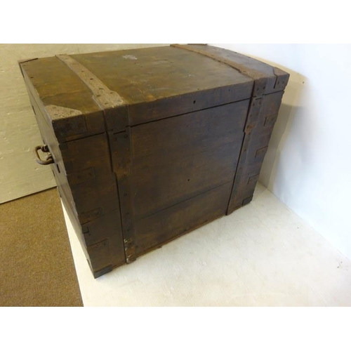 41 - Large antique timber and iron banded storage chest with metal carrying handles, the top with inscrib... 