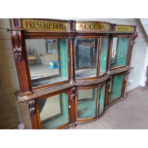 50 - Old Chemist shop cabinet as found. H. 174cm, D. 25cm, W. 240cm approx.  (Shelves missing)