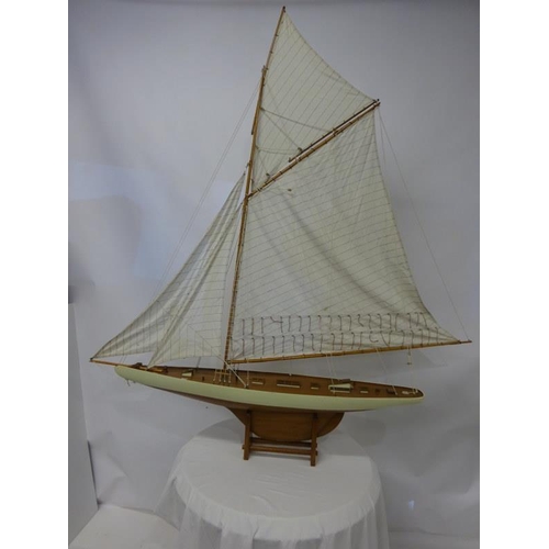 59 - Large timber model of a yacht on stand. L. 140cm.