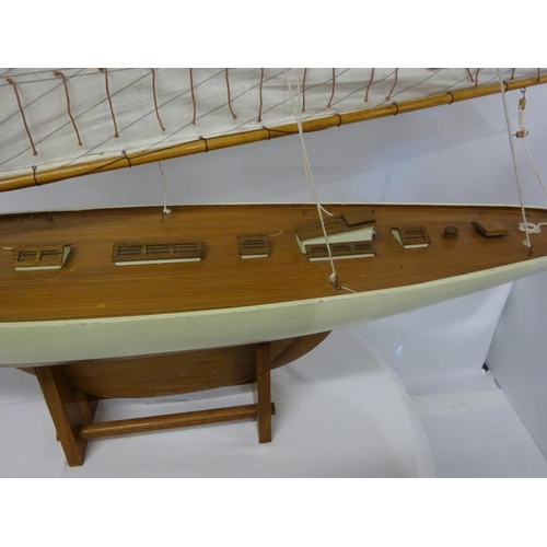 59 - Large timber model of a yacht on stand. L. 140cm.