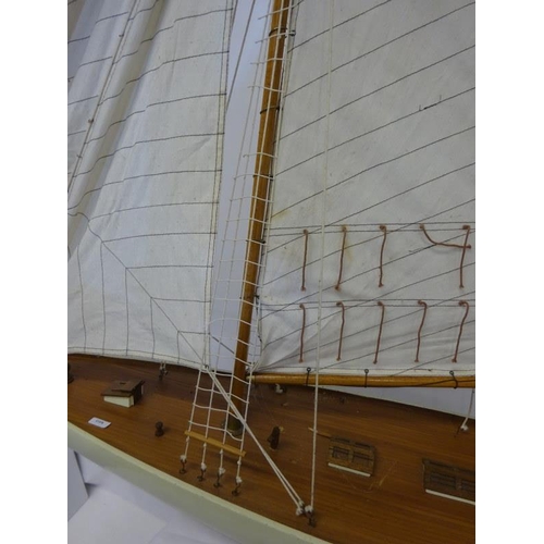 59 - Large timber model of a yacht on stand. L. 140cm.