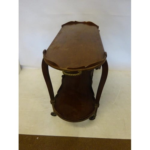 61 - Antique mahogany two tier trolley having brass handles shaped drop leaves and raised on wheels. W. 1... 