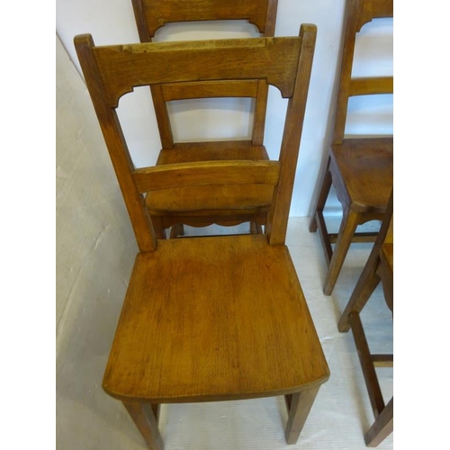 67 - A good set of 10 oak solid dining chairs raised on tapered legs.