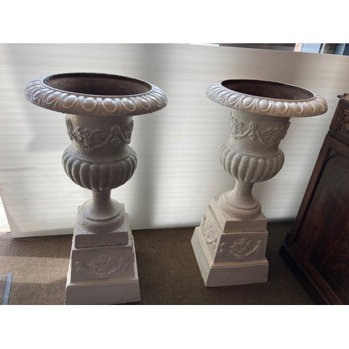 211 - A fine pair of large antique cast iron garden urns and bases. H. 110cm. Diameter 57cm.