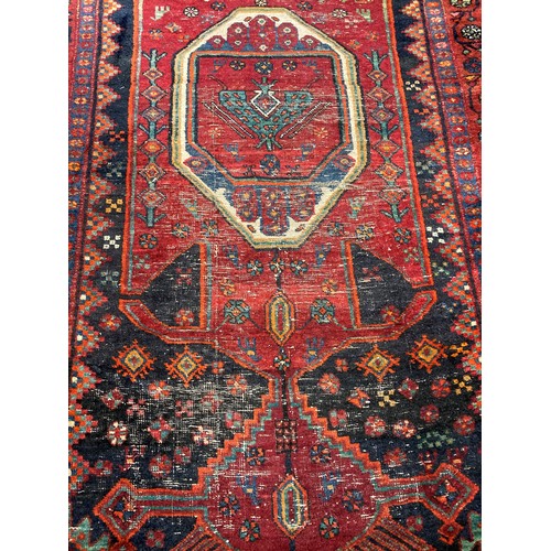 343 - Old Persian rug, centre worn. 276cm x 134cm.