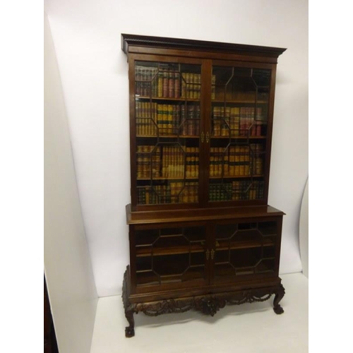 100 - An excellent quality Irish mahogany bookcase, the upper section having dental cornice over sectioned... 