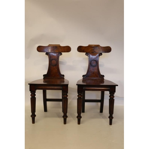 102 - A pair of good antique mahogany hall chairs.