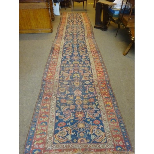 103 - A long old Persian runner rug. 485cm x 116cm.