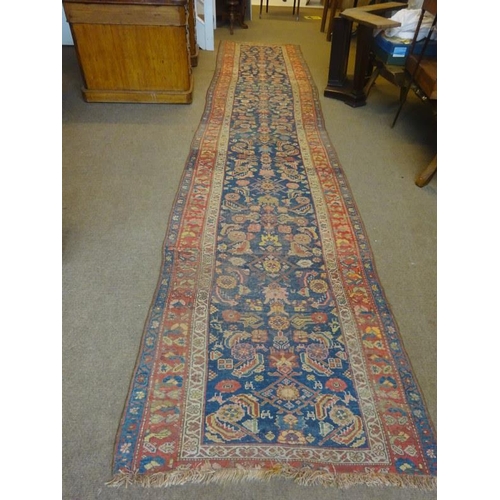 103 - A long old Persian runner rug. 485cm x 116cm.