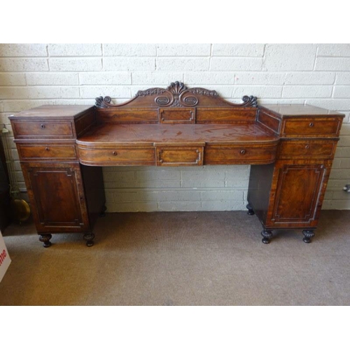 111 - A Regency mahogany drop centre sideboard having nicely carved back panel, the centre section fitted ... 