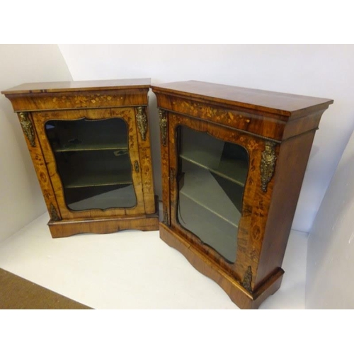 120 - A good pair of Victorian walnut and marquerty inlaid side cabinets having shaped doors and plinth ba... 