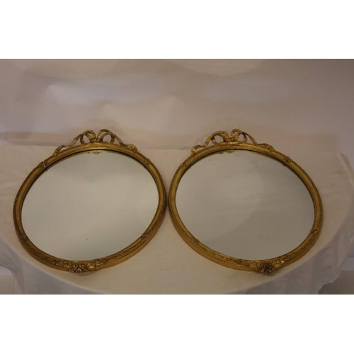 132 - A pair of antique neat sized gilt wood wall mirrors with ribbon decoration. H. 60cm, W. 43cm.