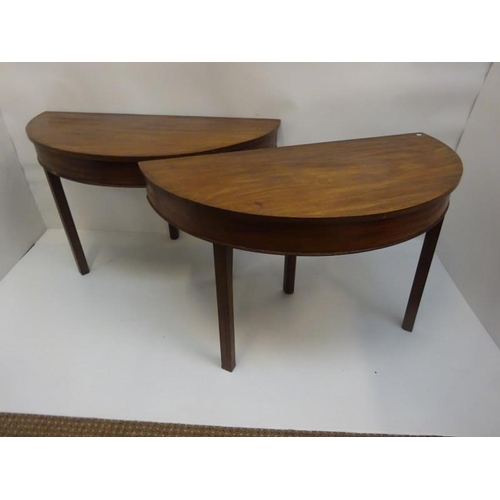 156 - A pair of Georgian mahogany demi lune tables raised on square chamfered legs. W. 120cm, D. 60cm, H. ... 