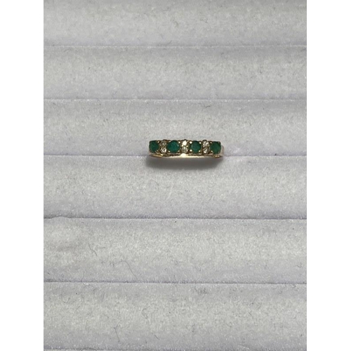 175 - 14ct yellow gold diamond and emerald half eternity ring. Size M.